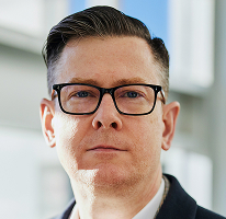 Fotografia di Alexander Hughes executive e CEO di società di trading di criptovalute
